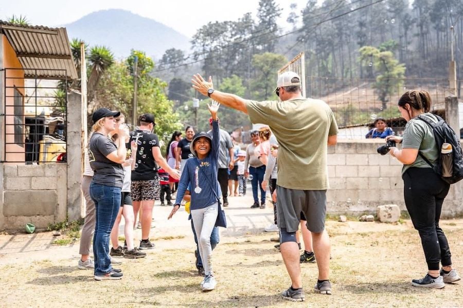 Team member high fives child in Guatemala